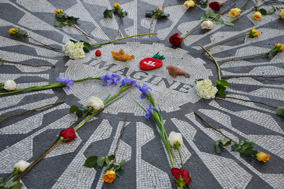 Strawberry Fields in Central Park with flowers thrown on it (Photo by by Sammy Six)